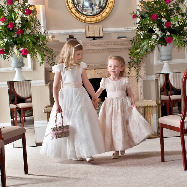 Flower girls walking down the aisle at The Royal Crescent Hotel's Wedding Venue in Bath.