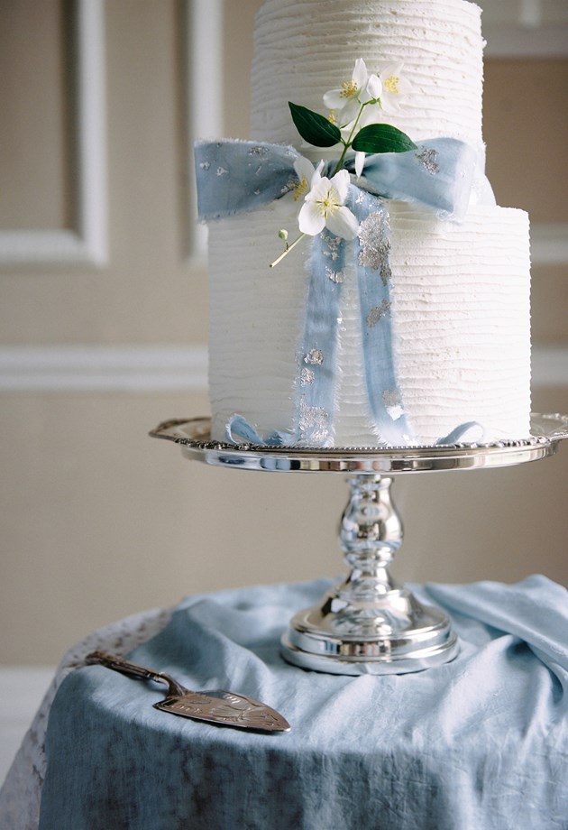 Beautiful wedding cake on a silver platter.